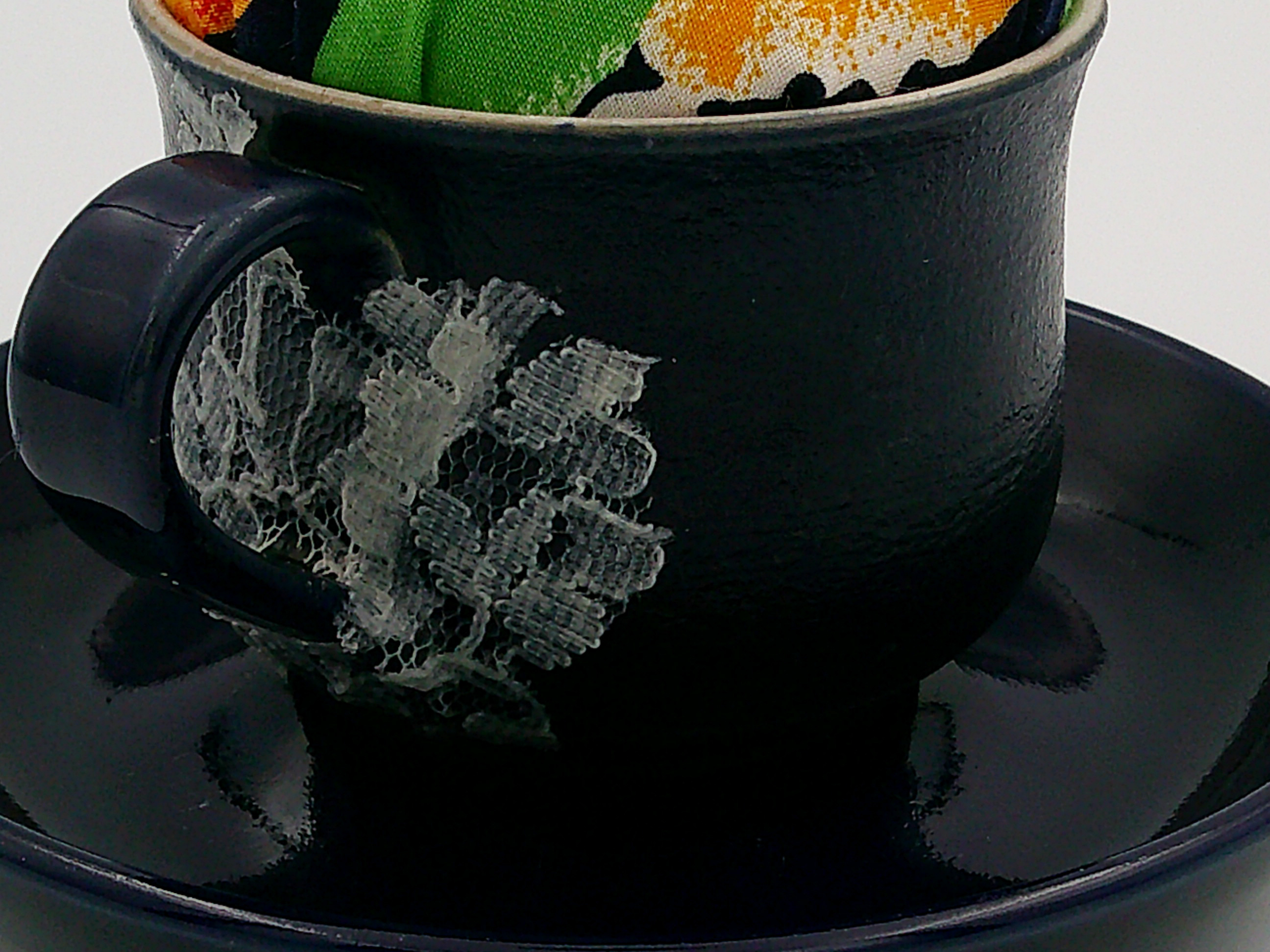 This shows the back of the cup with the the lace decoupage covering the crack. It is a nice contrast with the midnight blue. This shows the back of the cup with the the lace decoupage covering the crack. It is a nice contrast with the midnight blue.